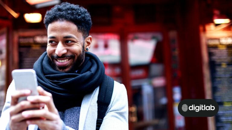 digital marketing for fintech companies - man outside wearing a scarf smiling at his mobile phone