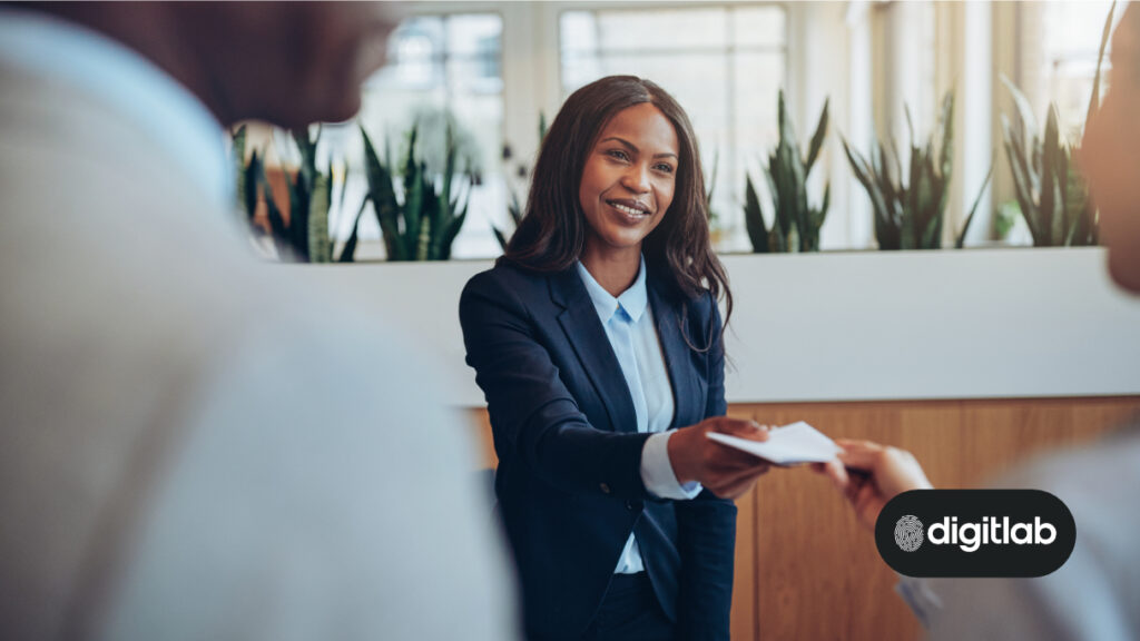 digital marketing strategies for hotels - friendly woman standing at hotel reception desk.