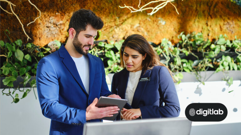 Hotel Search Engine Marketing - man and woman standing at hotel reception desk looking at an ipad.