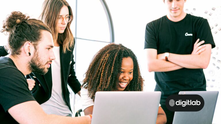 Lead acquisition for startups - four colleagues looking excitedly at a computer screen.