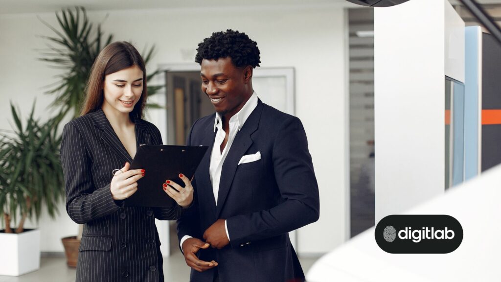 Hubspot consulting for success - woman and man in suits looking at tablet device.