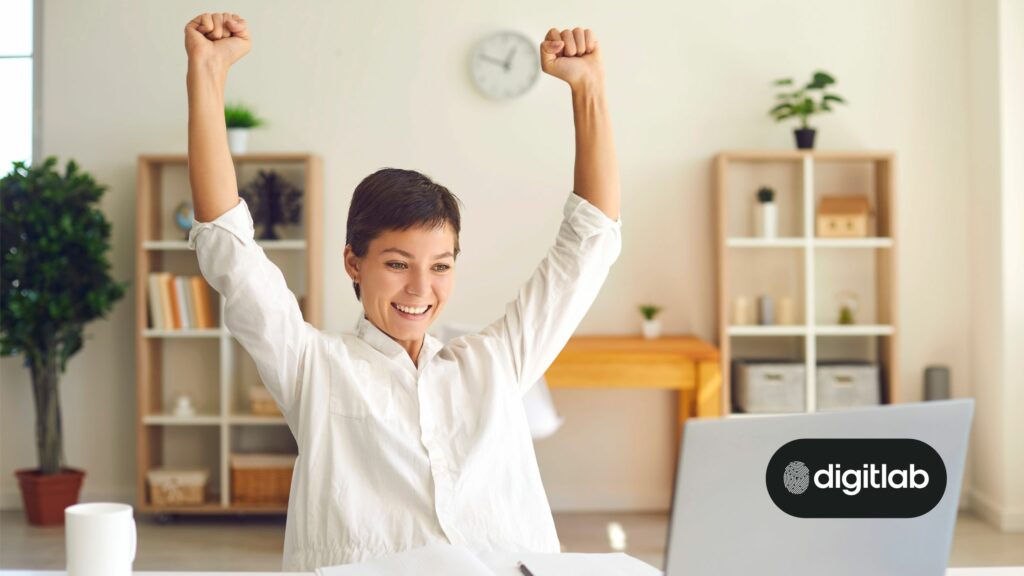 Marketing tips for startups - woman sitting behind laptop putting her hands up.